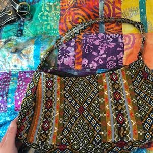 Small purse with one strap. Multi color zip closure that works .